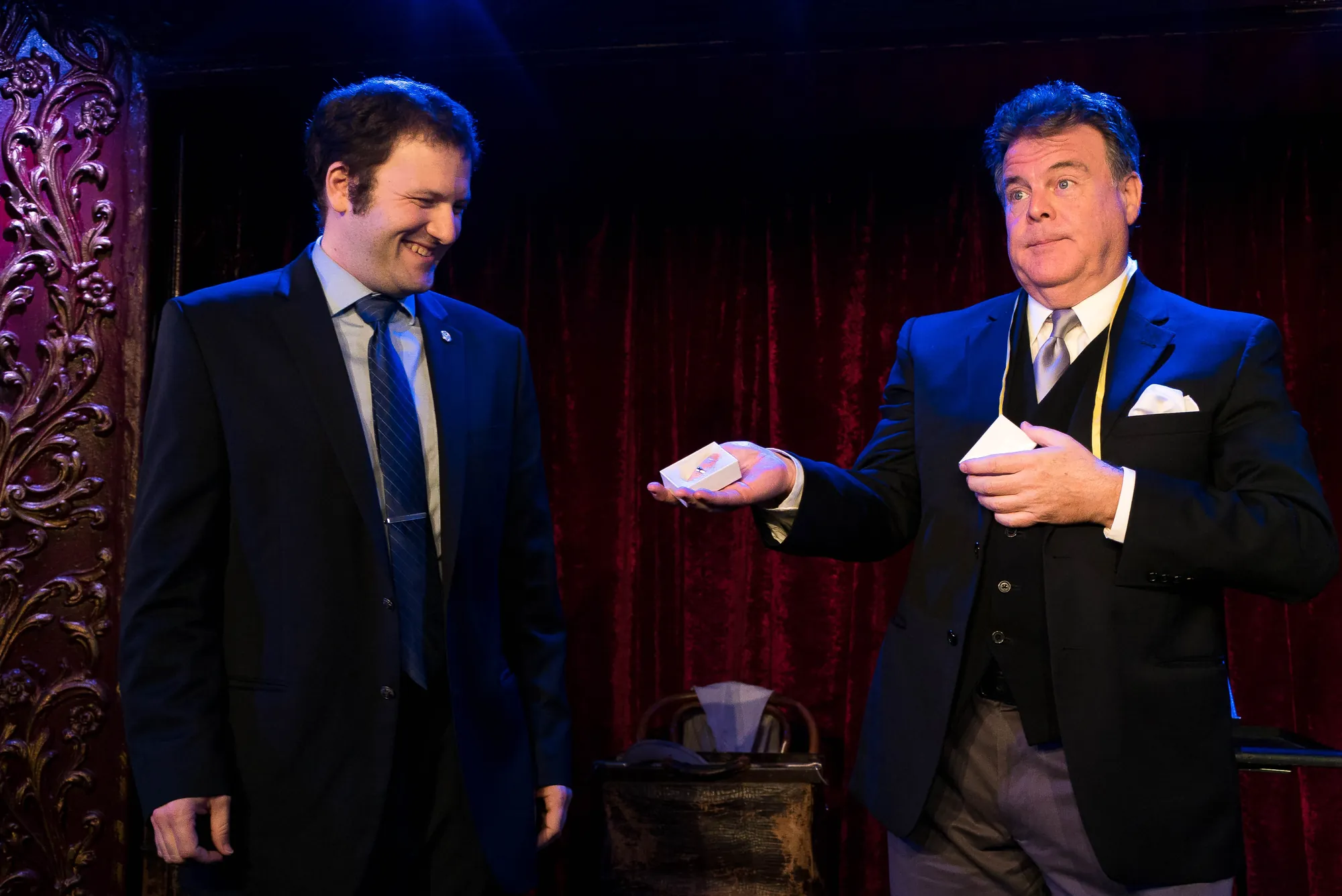 John Carney performing a card-and-glass illusion